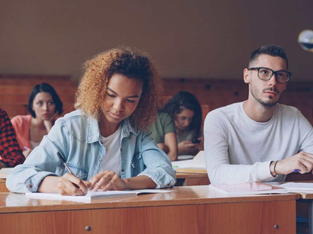 Students taking notes during a lecture